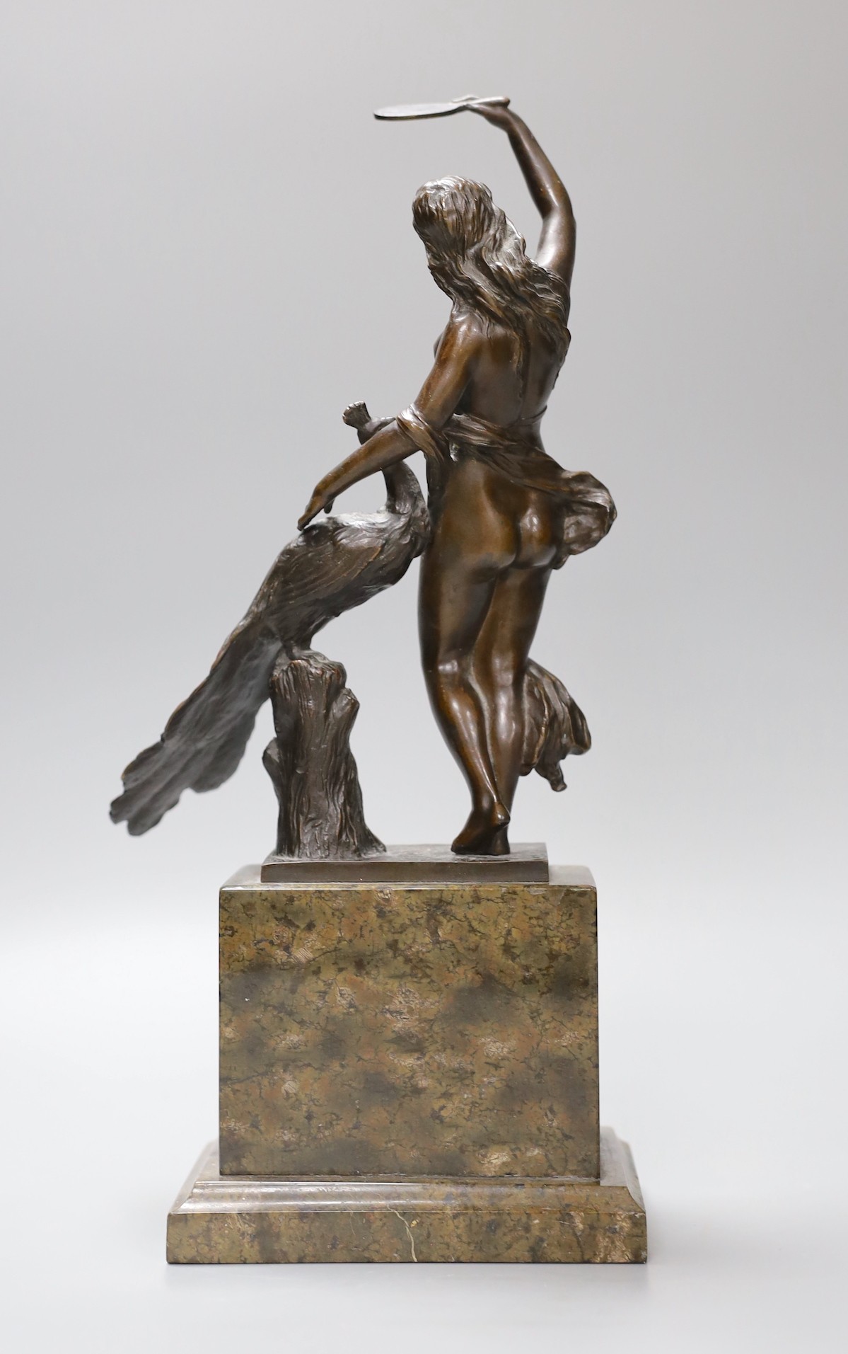 A bronze female and peacock group on plinth base, 32cm tall